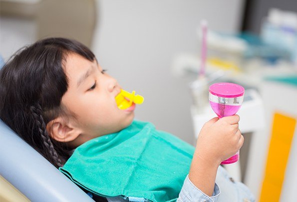 Child receiving fluoride treatment