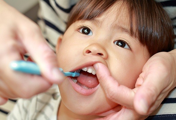 Young child during exam for lip and tongue tie