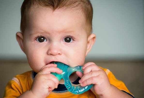 Baby chewing on teeth ring