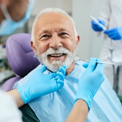 An older man receiving care from a dentist 