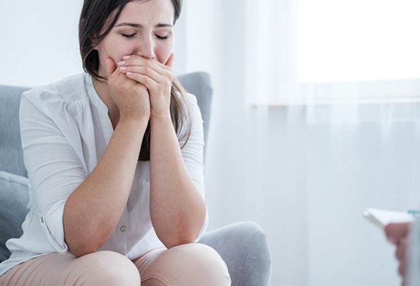 Woman with a toothache in Everett holding her mouth