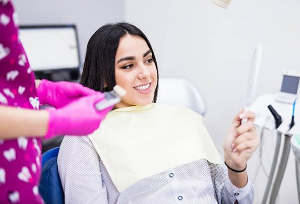 Woman learning cost of treating dental emergencies in Everett