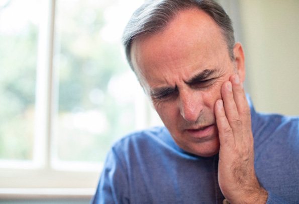 A man suffering a dental emergency