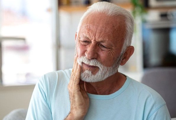 a patient experiencing tooth pain due to dental implant failure