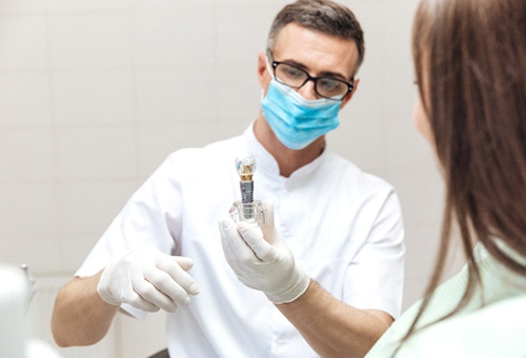 Dentist performing dental implant consultation