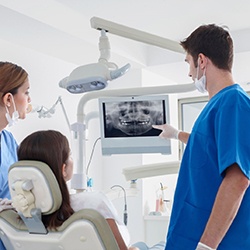 dentist showing a patient their dental X-rays 