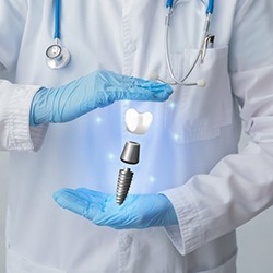 dentist with a hologram of a dental implant in their hands 