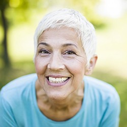 woman with dental implants in Everett grinning from ear to ear 