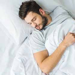 Man resting after receiving dental implants in Everett