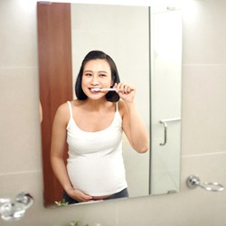 Woman with dental implants in Everett brushing her teeth