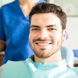 Man smiling while visiting his implant dentist in Everett