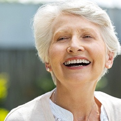 Older woman with dental implants in Everett smiling