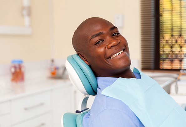 man smiling after using dental implant technology in Everett