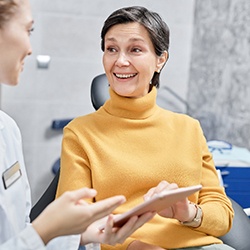 Smiling patient and dentist discussing nitrous oxide in office