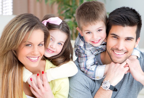 Smiling mother father and two children