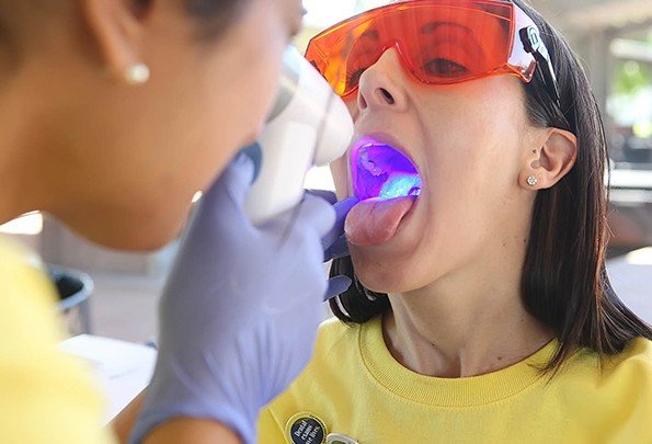 Patient receiving oral cancer screening