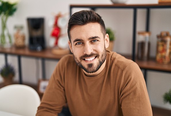 a man smiling after undergoing root canal therapy