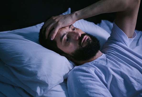 Man with sleep apnea lying awake at night