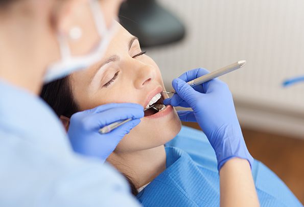 Relaxed woman receiving dental treatment under sedation dentistry