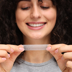 Woman using a whitening strip