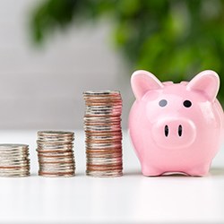 Coins next to a piggy bank