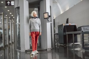 woman walking through metal detector