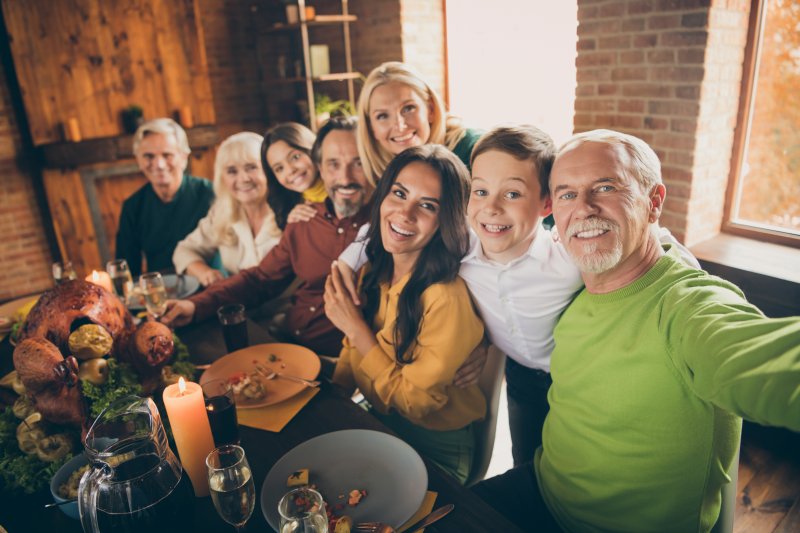 A family celebrating Thanksgiving after the dad’s dental implant treatment