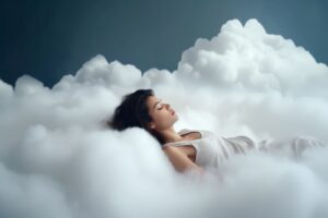 Woman in white nightgown sleeping on clouds
