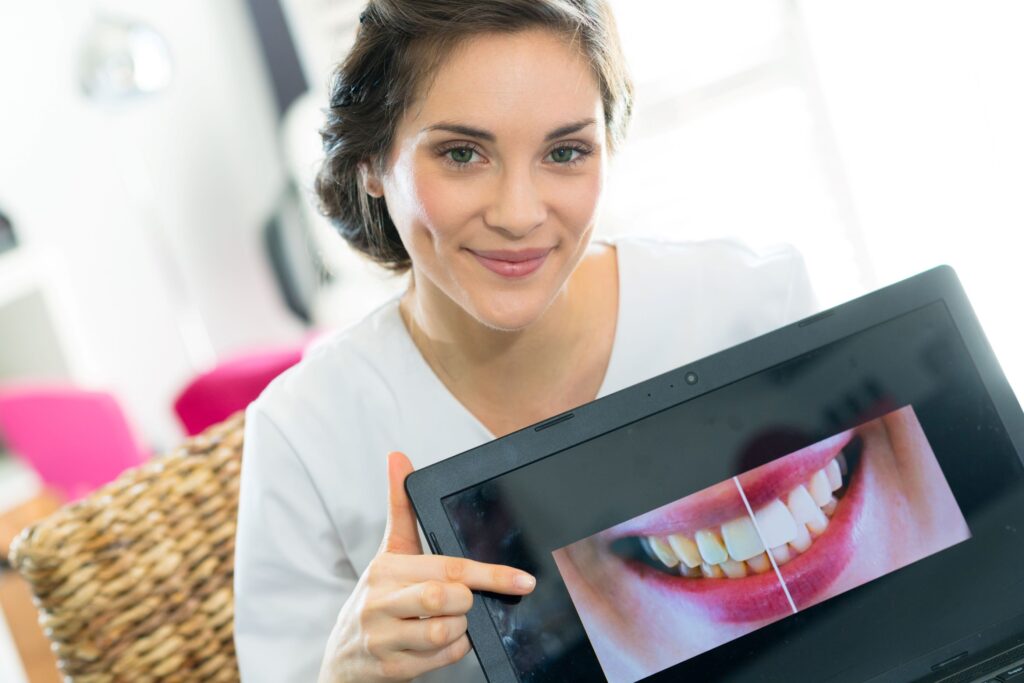 Woman holding picture of smile showing results of cosmetic dentistry