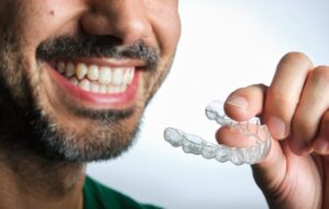 Man putting on his Invisalign 