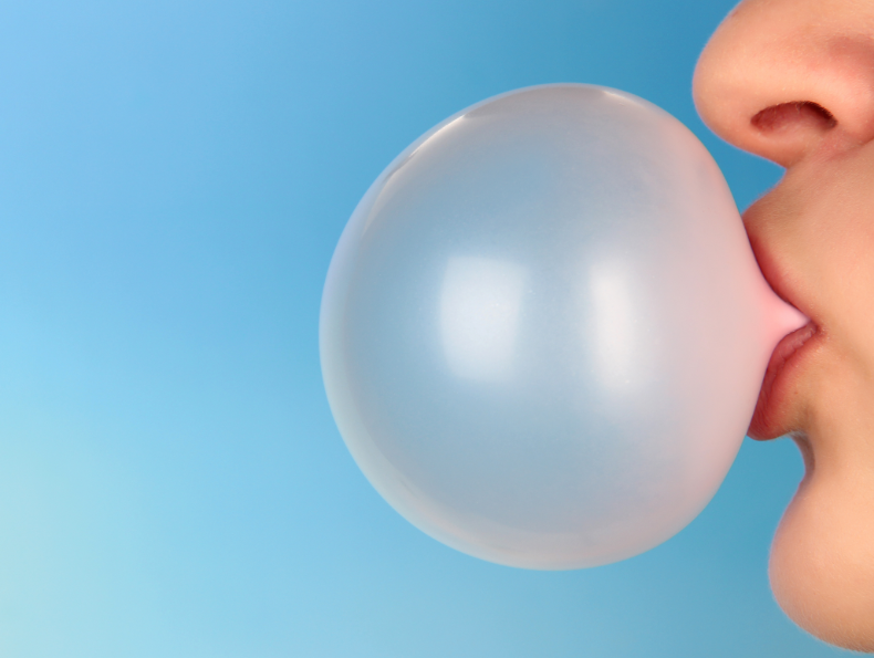 Close up of mouth blowing bubble gum bubble