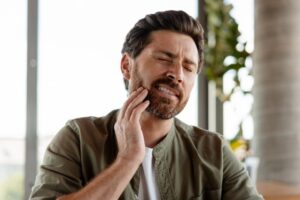 Man experiencing jaw pain